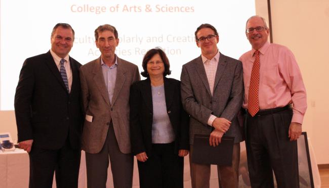 Dean of the College of Arts and Sciences Leonidas Bachas and Provost Thomas J. LeBlanc stand with Cooper Fellows Professor Michael Miller, Professor Gail Ironson, and Professor Francisco Raymo. 